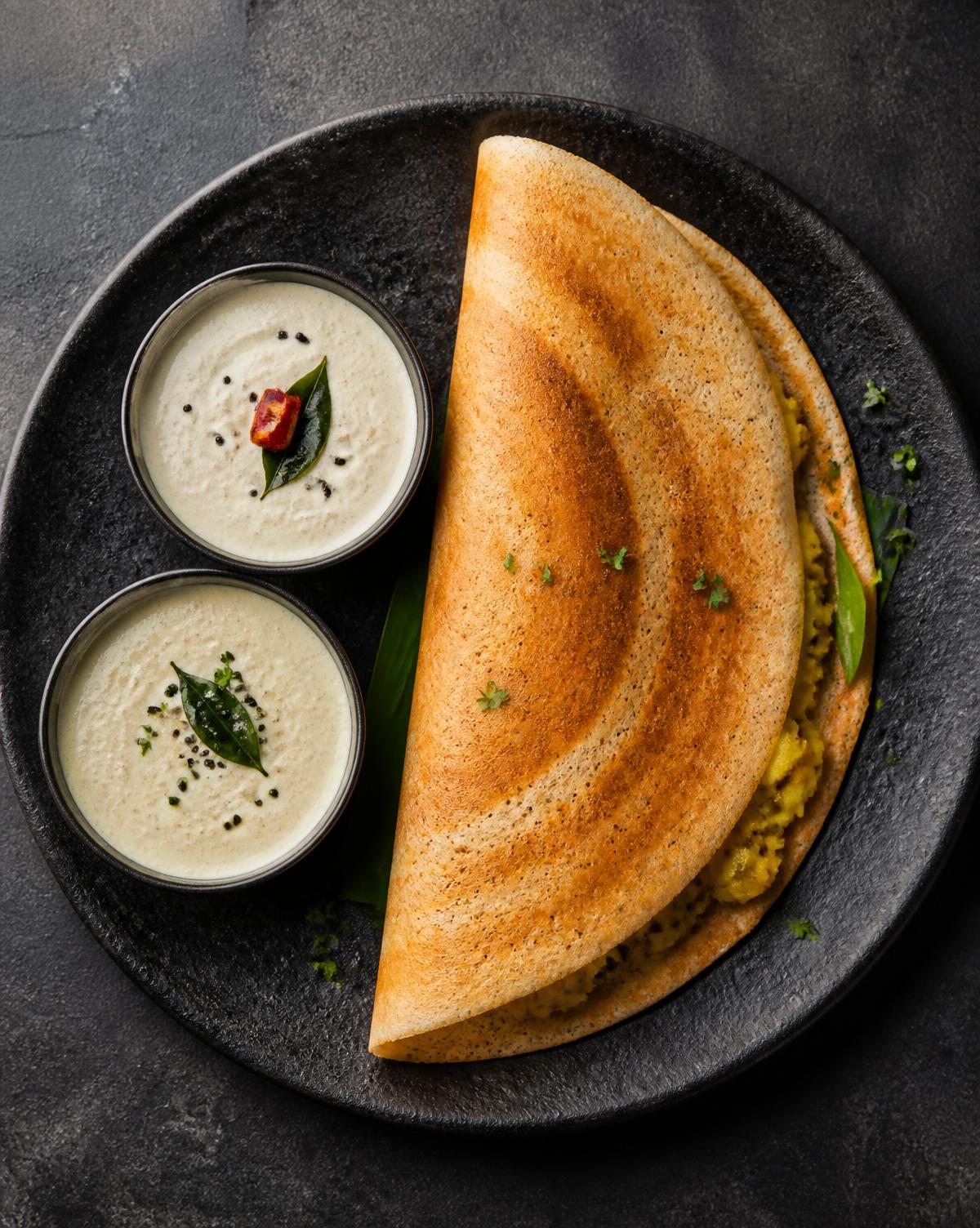 Golden masala dosa with South Indian chutneys